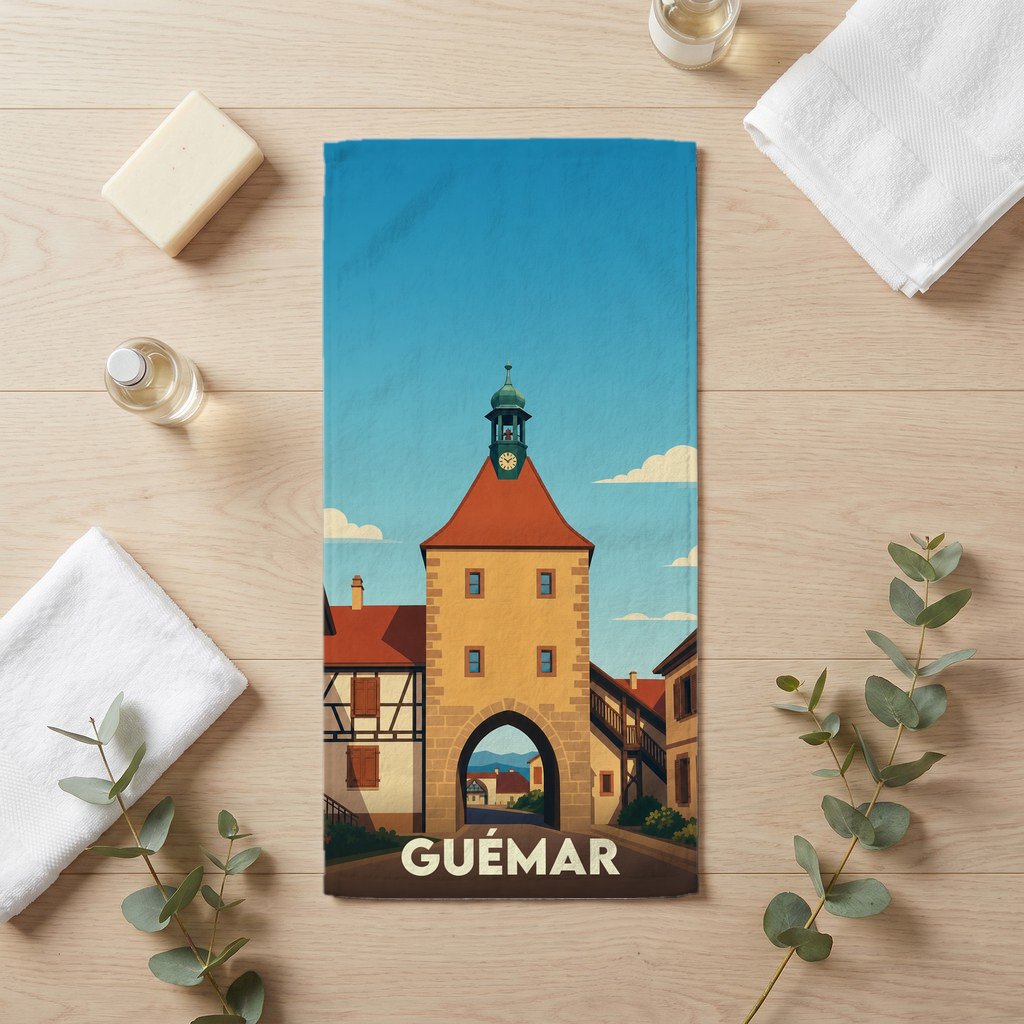 Serviette de bain souvenir de la ville de Guémar avec une illustration stylisée de sa tour historique.