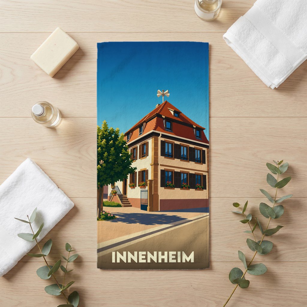 Serviette de bain souvenir de la ville de Innenheim avec une illustration stylisée d'une maison traditionnelle.