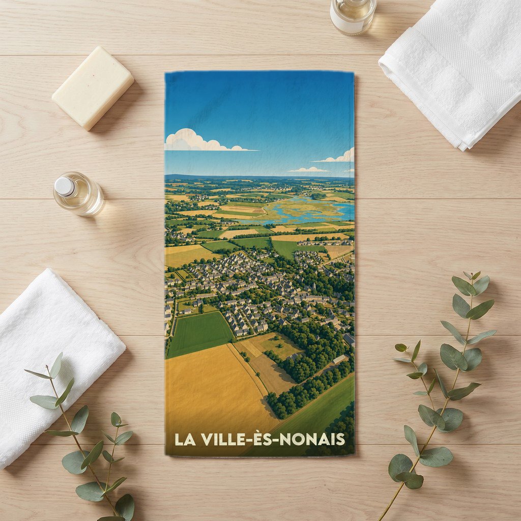 Serviette de bain souvenir de La Ville-ès-Nonais avec une illustration paysagère stylisée.