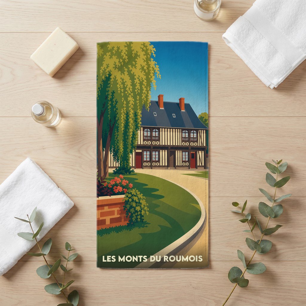 Serviette de bain souvenir de la ville de Les Monts du Roumois avec une illustration stylisée d'une maison traditionnelle normande.
