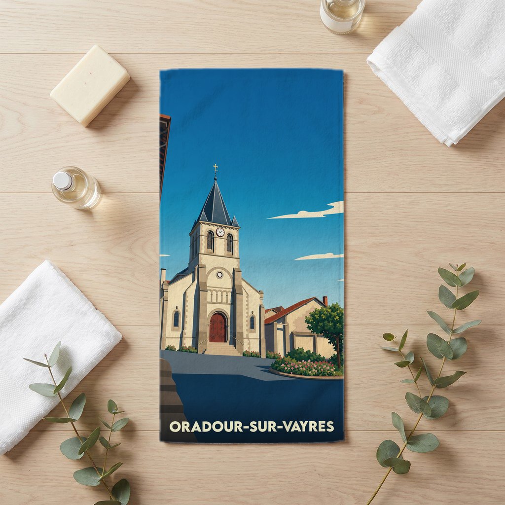 Serviette de bain souvenir de la ville d'Oradour-sur-Vayres illustrée d'une église sous un ciel bleu.
