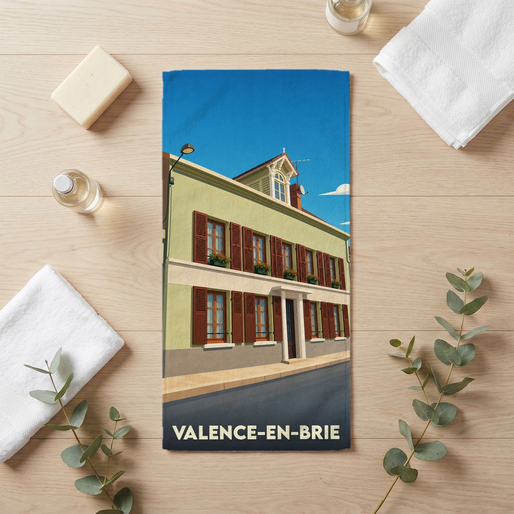 Serviette de bain souvenir de la ville de Valence-en-Brie avec une illustration stylisée d'un bâtiment traditionnel.
