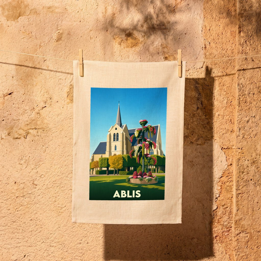 Torchon souvenir de la ville d'Ablis avec une illustration stylisée de son église et d'un massif floral.
