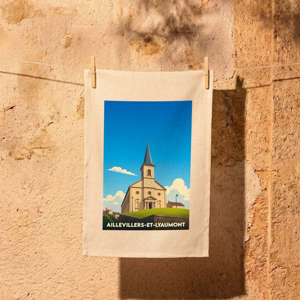 Torchon souvenir de la ville de Aillevillers-et-Lyaumont avec une illustration stylisée de son église sous un ciel bleu.