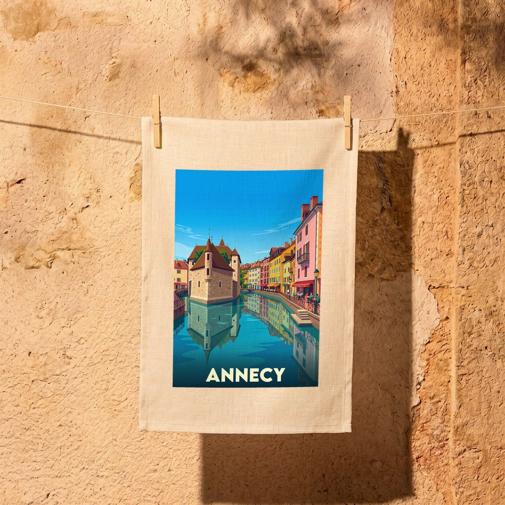 Torchon souvenir de la ville d'Annecy avec une illustration stylisée de ses célèbres canaux.