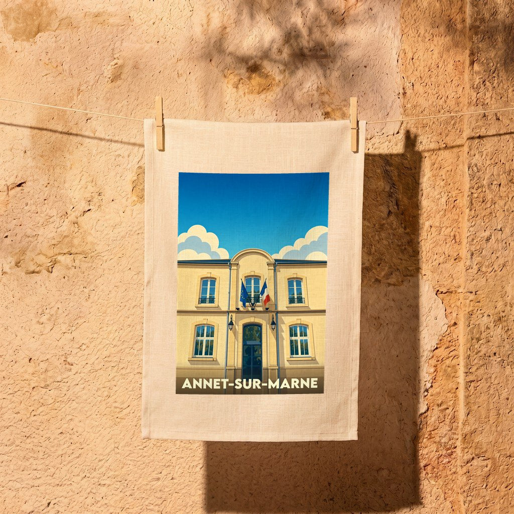 Torchon souvenir de la ville d'Annet-sur-Marne illustrant sa mairie sous un ciel bleu.