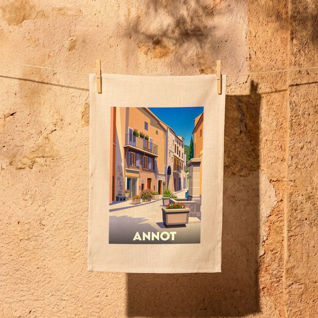 Torchon souvenir de la ville d'Annot orné d'une illustration stylisée de ses ruelles ensoleillées.