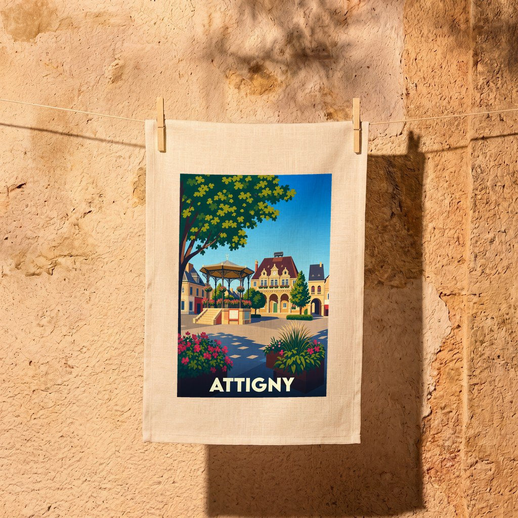 Torchon souvenir de la ville de Attigny illustré par une scène de place de village stylisée.