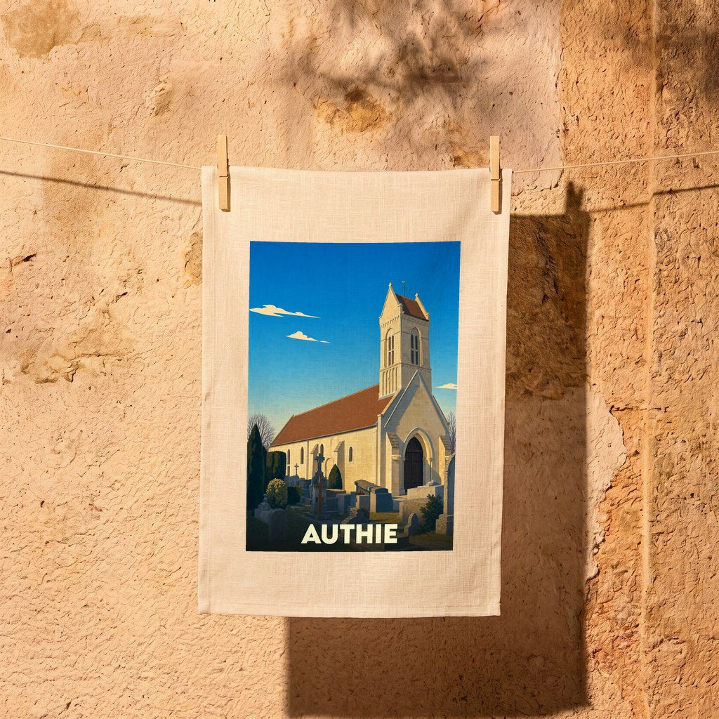 Torchon souvenir de la ville d'Authie avec une illustration stylisée de son église et de son cimetière.