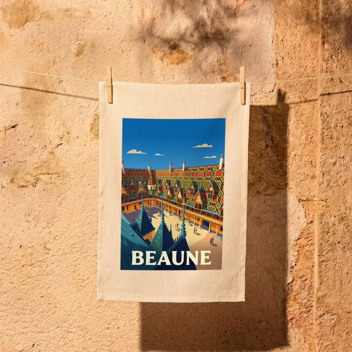 Torchon souvenir de la ville de Beaune avec une illustration stylisée de ses célèbres toits colorés.