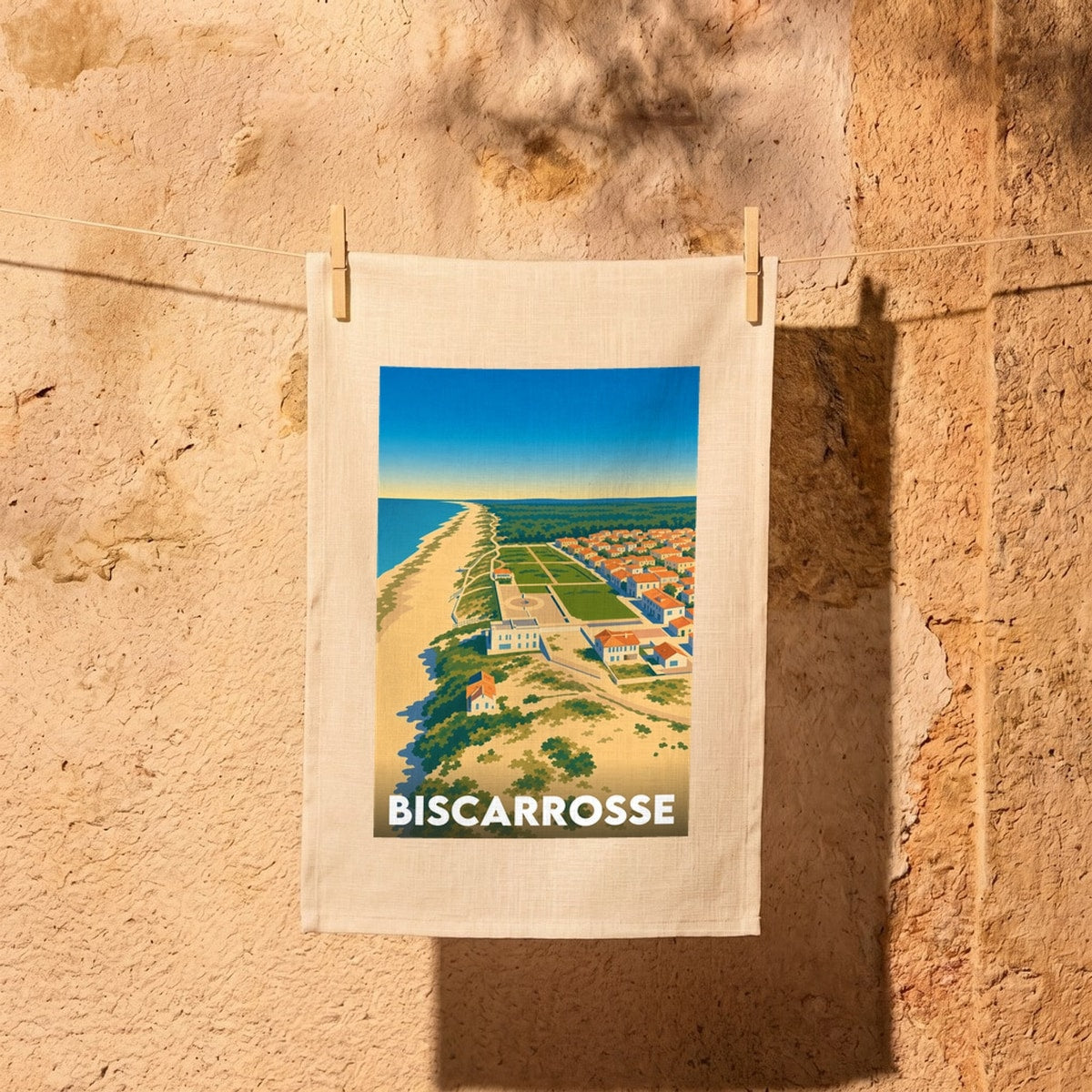 Torchon souvenir de la ville de Biscarrosse avec une illustration stylisée de son paysage côtier.