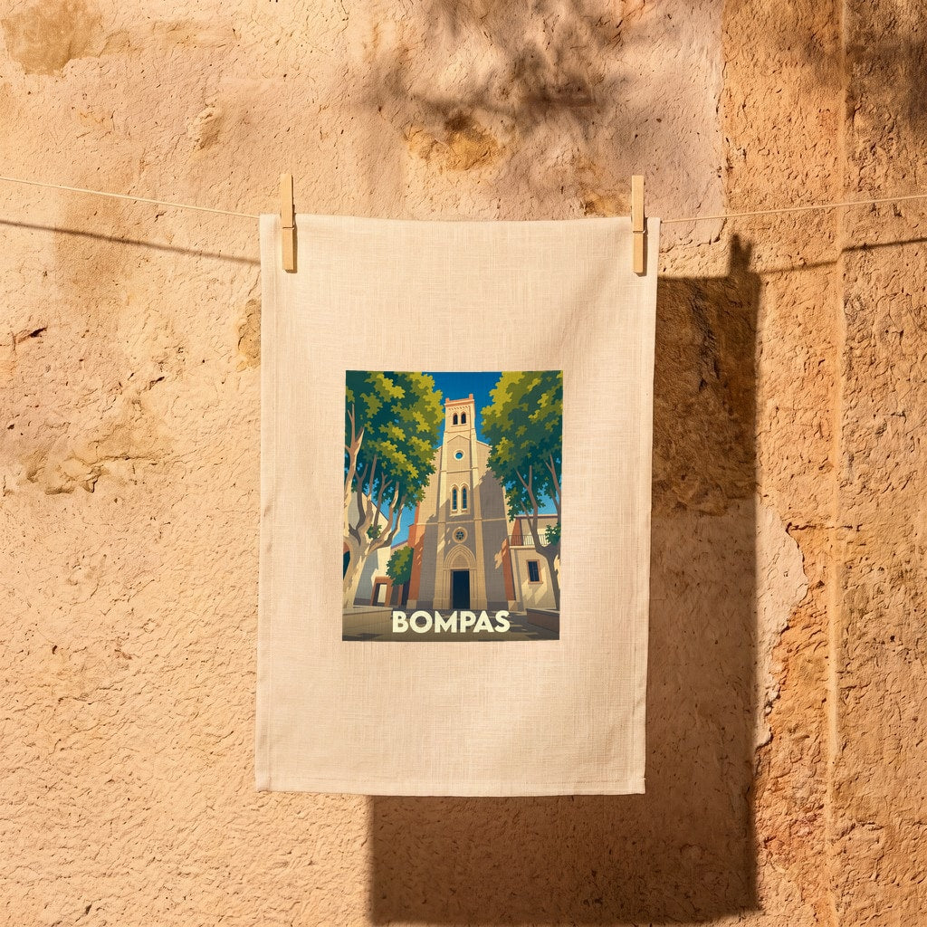 Torchon souvenir de la ville de Bompas avec une illustration stylisée de son église et de ses platanes.