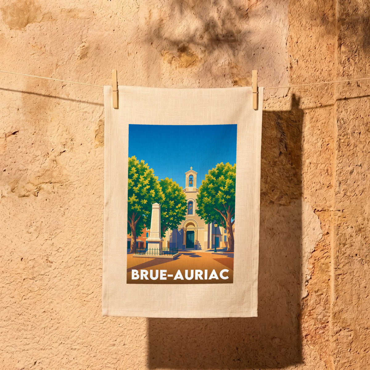 Torchon souvenir de la ville de Brue-Auriac avec une illustration stylisée.