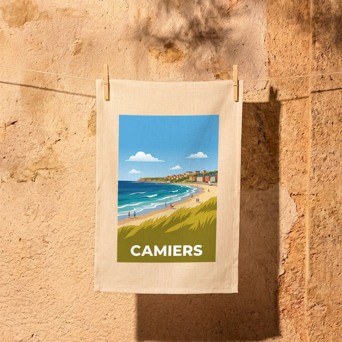 Torchon souvenir de la ville de Camiers avec une illustration stylisée de sa plage et de ses dunes.