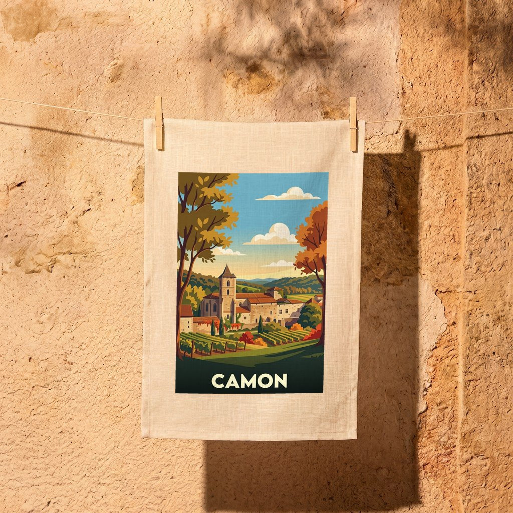 Torchon souvenir de la ville de Camon avec une illustration stylisée de son abbaye et de ses vignobles.