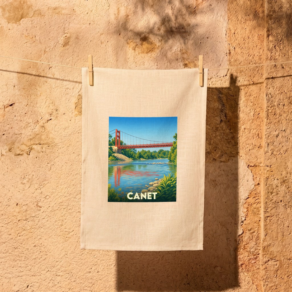 Torchon souvenir de la ville de Canet avec une illustration stylisée d'un pont suspendu enjambant une rivière.