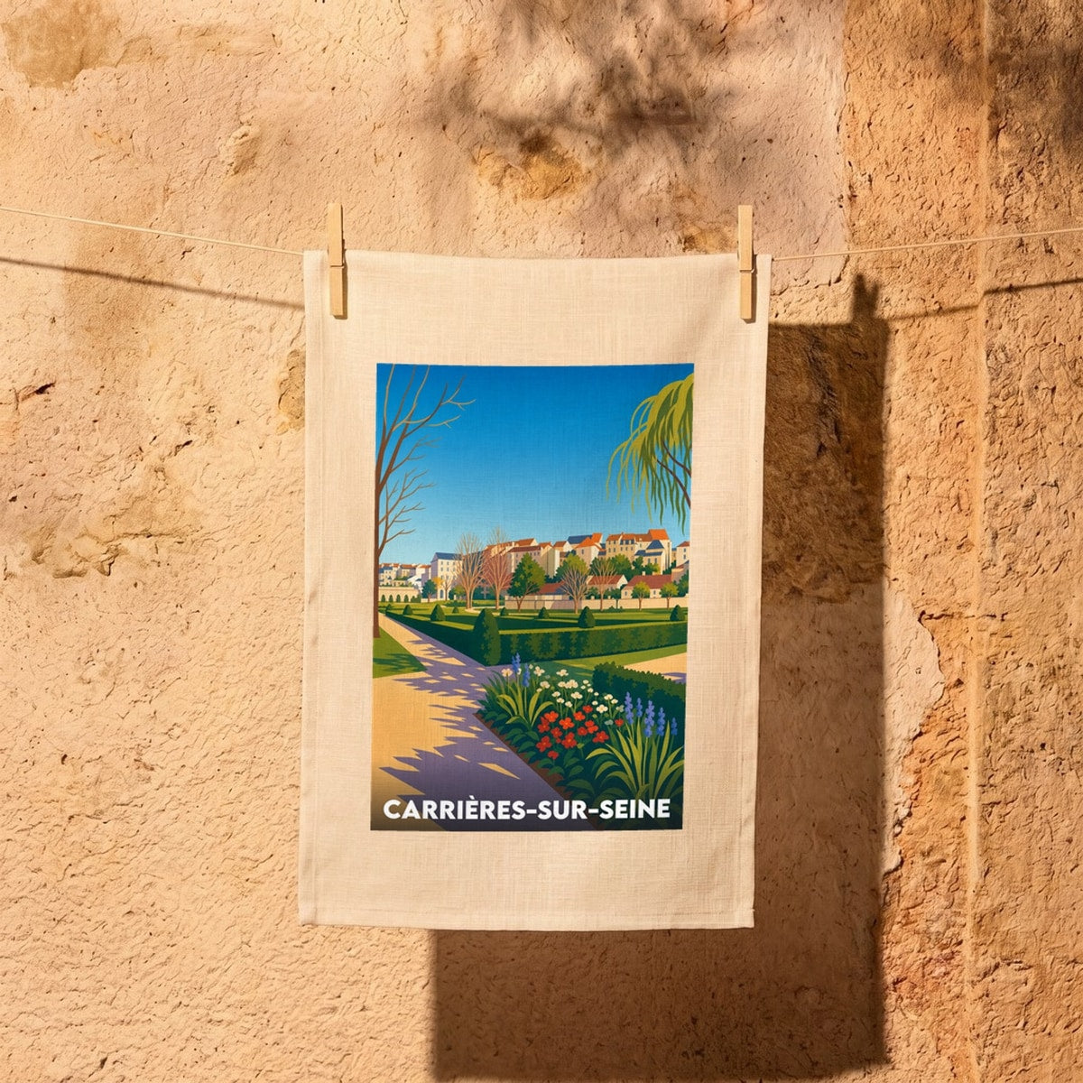 Torchon souvenir de la ville de Carrières-sur-Seine avec une illustration stylisée d'un parc.