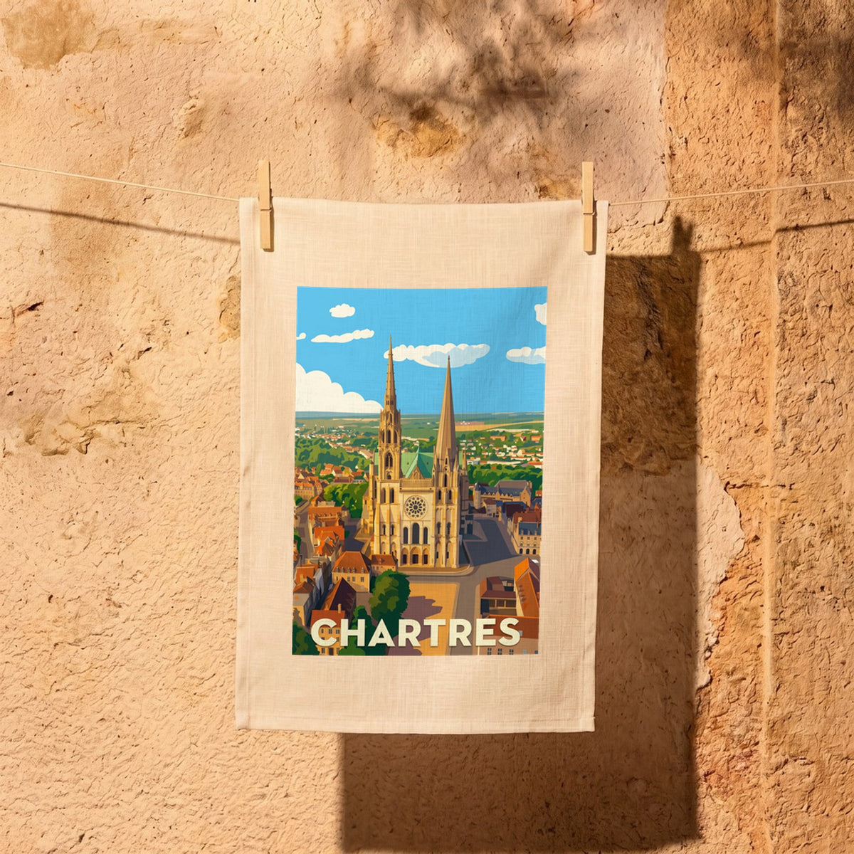 Torchon souvenir de la ville de Chartres avec une illustration stylisée de sa cathédrale.