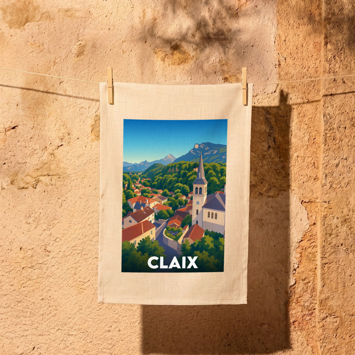 Torchon souvenir de la ville de Claix orné d'une illustration stylisée de son paysage et de son église.
