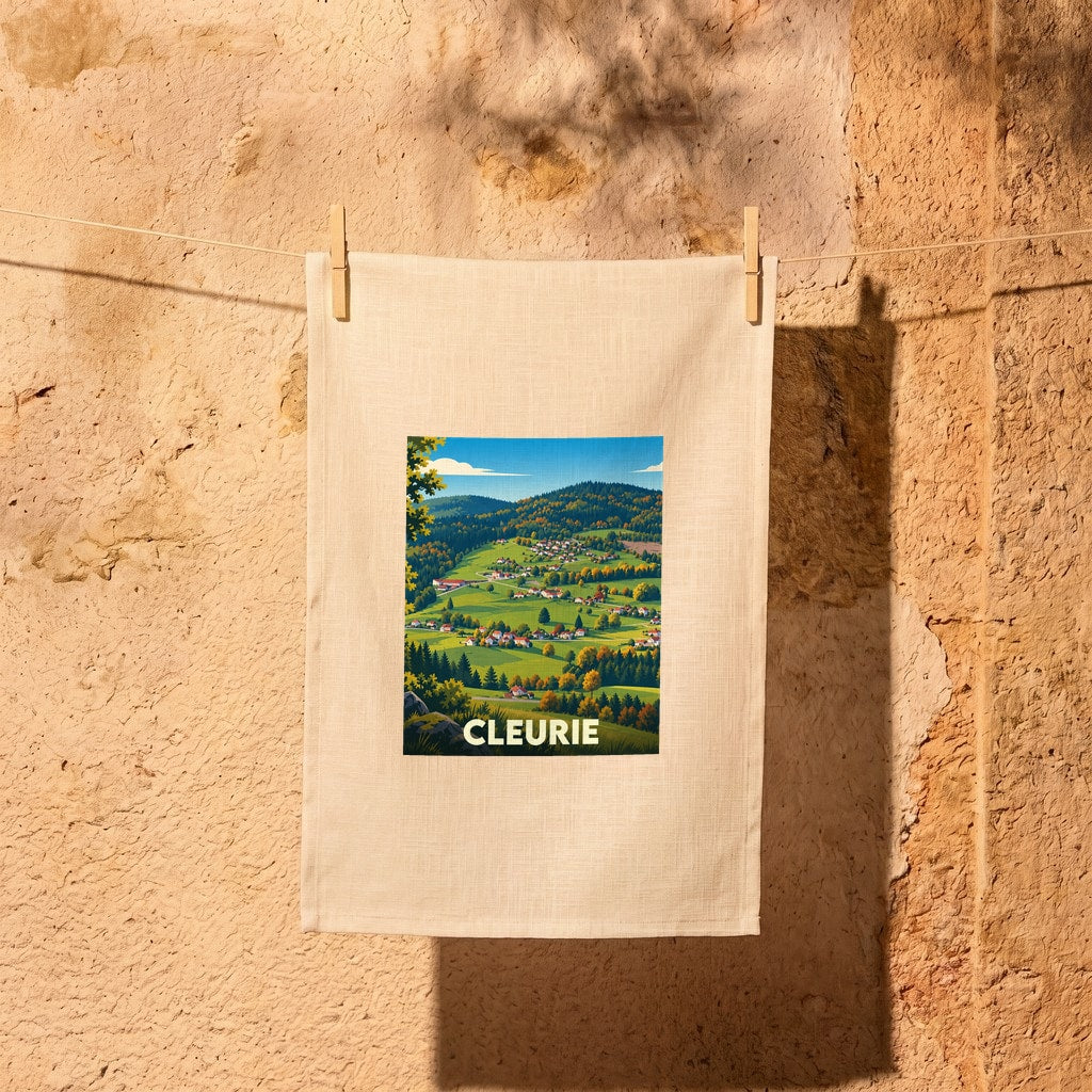 Torchon souvenir de la ville de Cleurie avec une illustration paysagère stylisée.