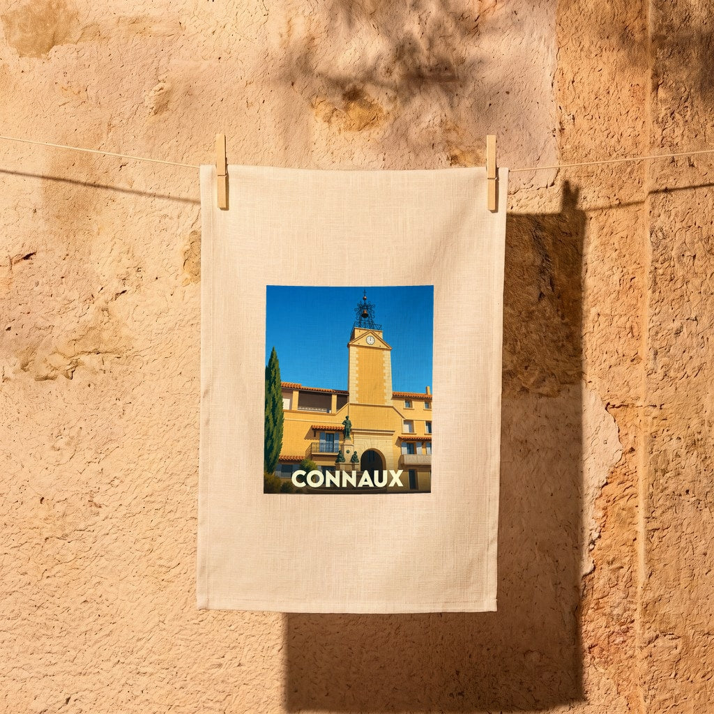 Torchon souvenir de la ville de Connaux illustré d'une scène urbaine ensoleillée.