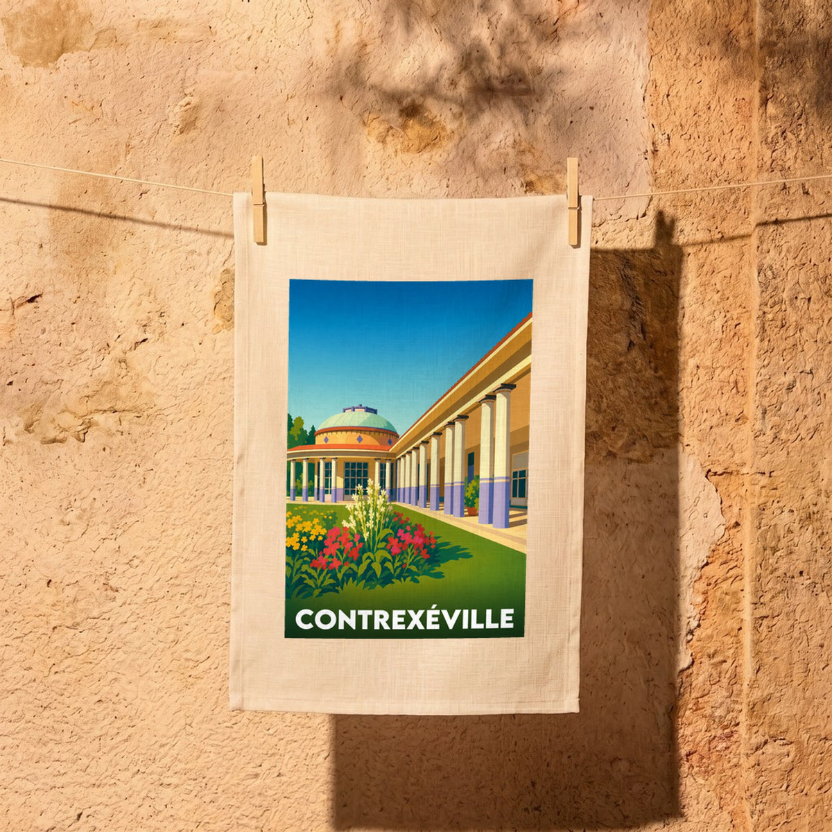 Torchon souvenir de la ville de Contrexéville avec une illustration stylisée de son architecture thermale.