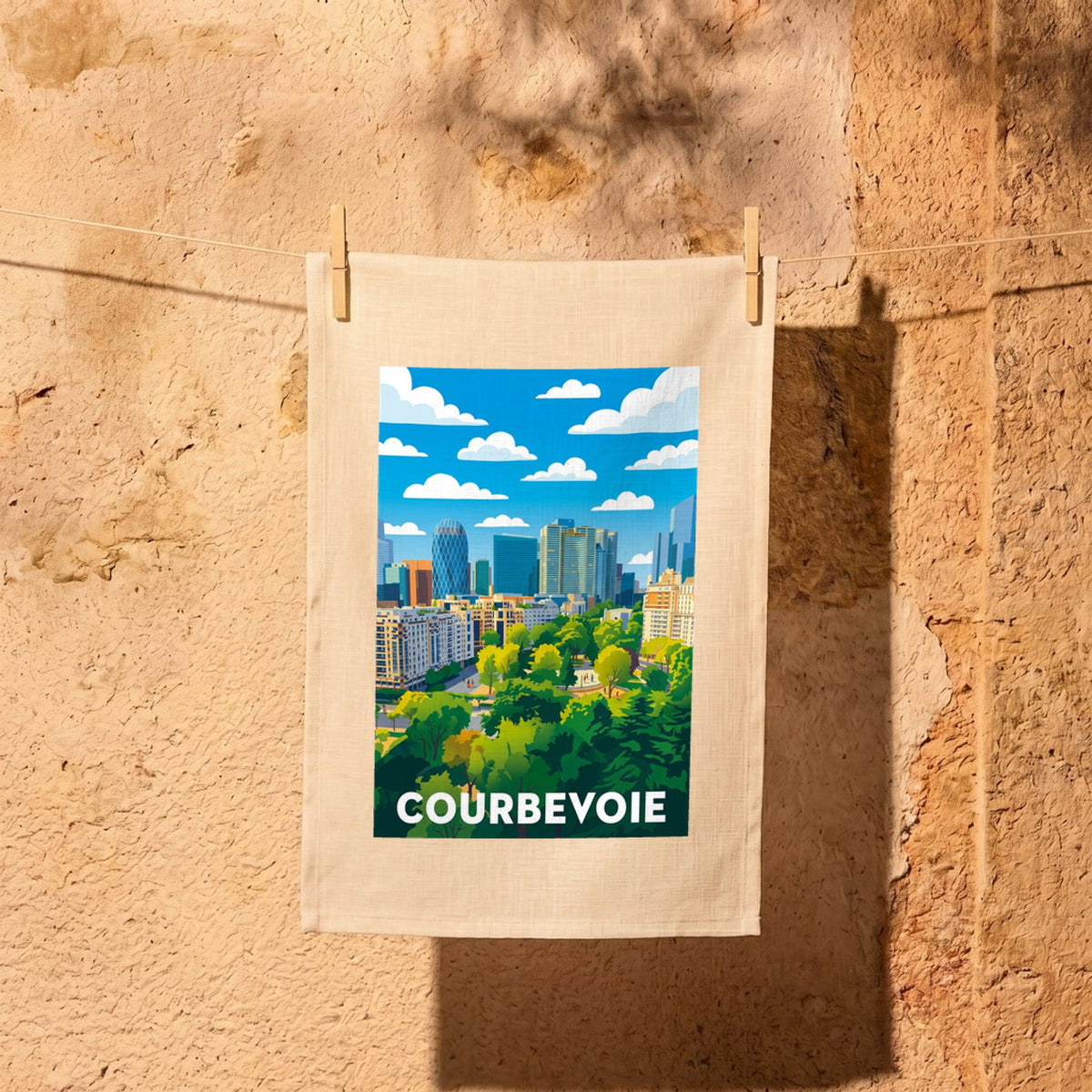 Torchon souvenir de la ville de Courbevoie avec une illustration stylisée de son paysage urbain.