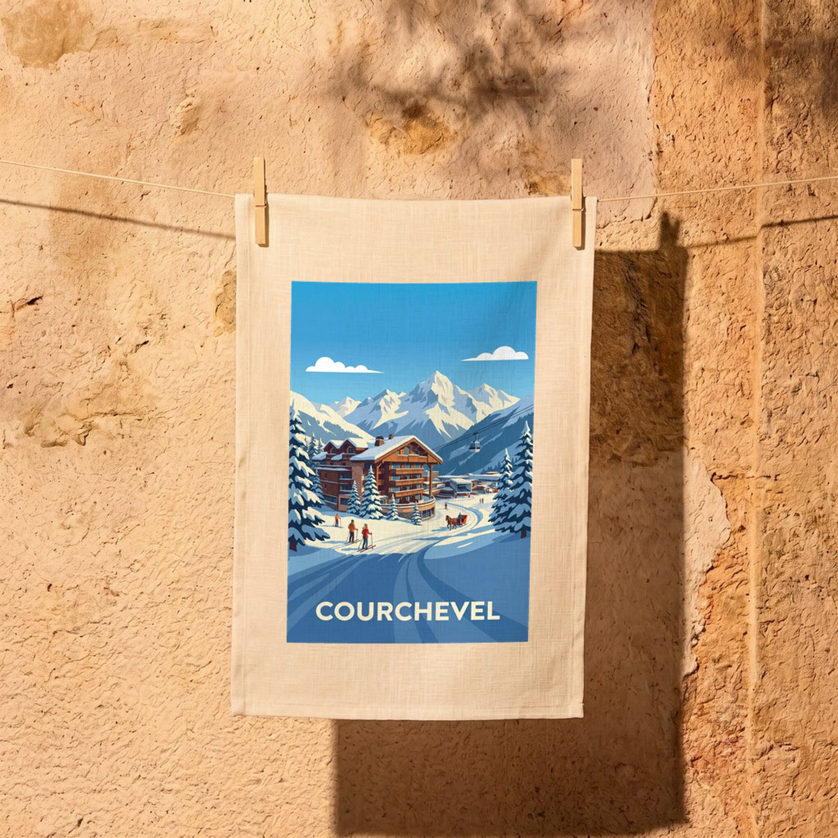 Torchon souvenir de la ville de Courchevel avec une illustration stylisée d'un paysage de montagne enneigé.