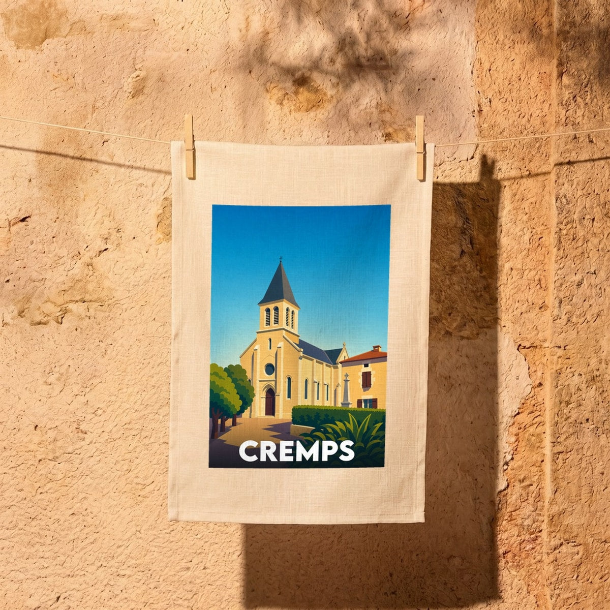 Torchon souvenir de la ville de Cremps avec une illustration stylisée de son église.