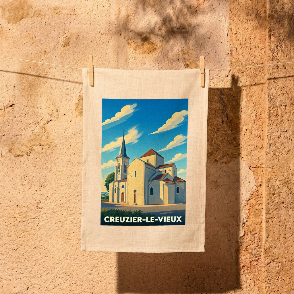 Torchon souvenir de la ville de Creuzier-le-Vieux illustré d'une vue stylisée de son église sous un ciel bleu.