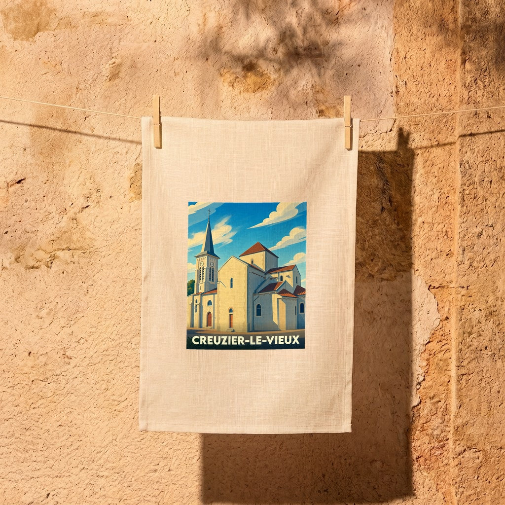 Torchon souvenir de la ville de Creuzier-le-Vieux illustré d'une vue stylisée de son église sous un ciel bleu.