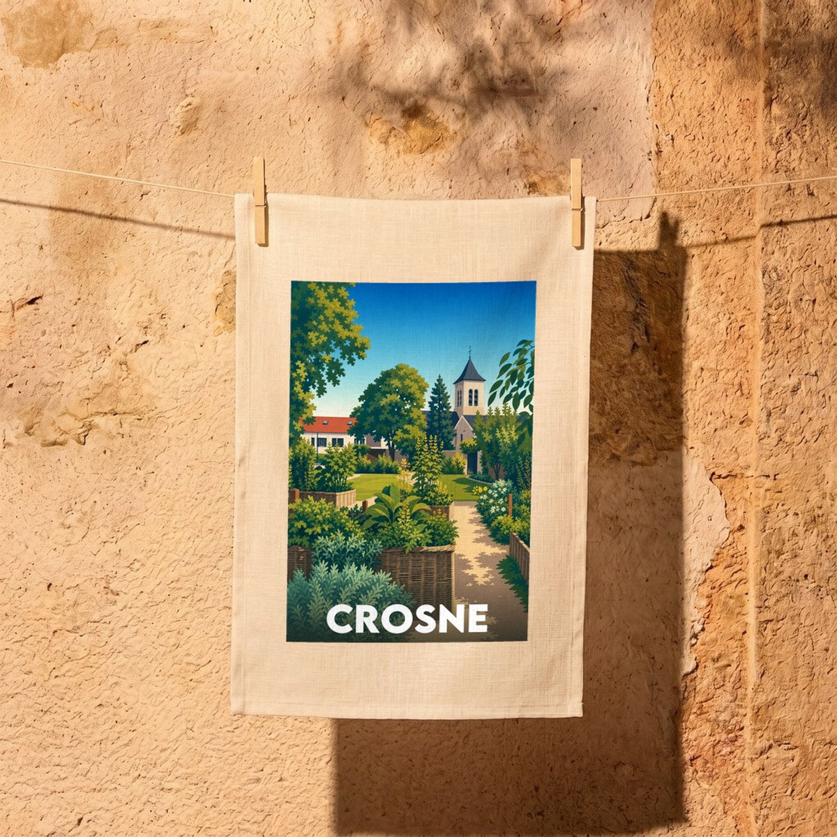 Torchon souvenir de la ville de Crosne avec une illustration stylisée représentant son église et ses jardins.