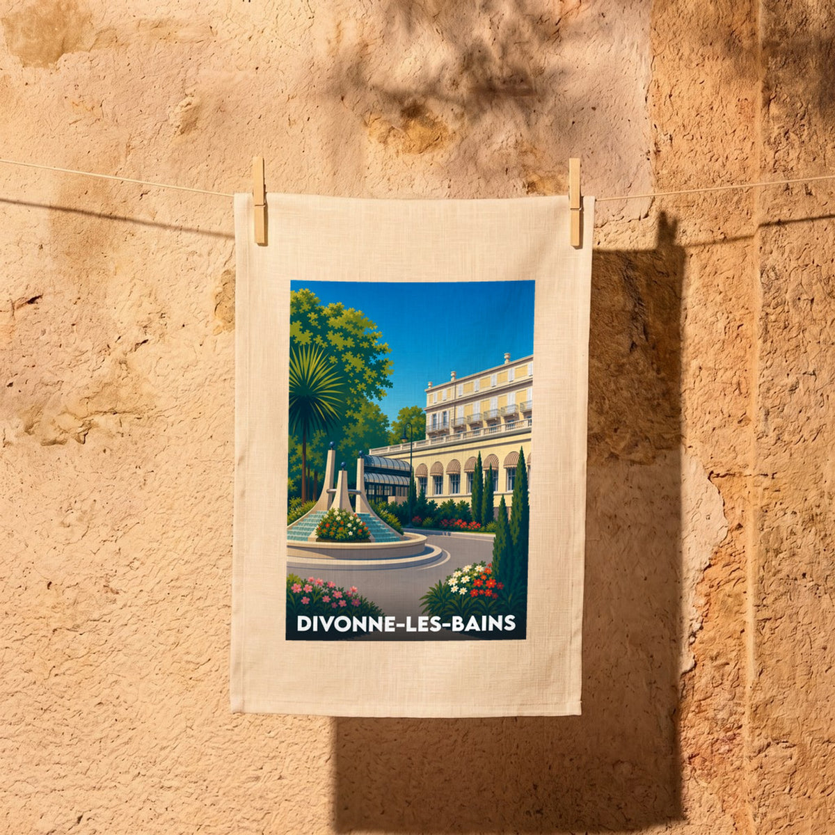 Torchon souvenir de la ville de Divonne-les-Bains avec une illustration stylisée.
