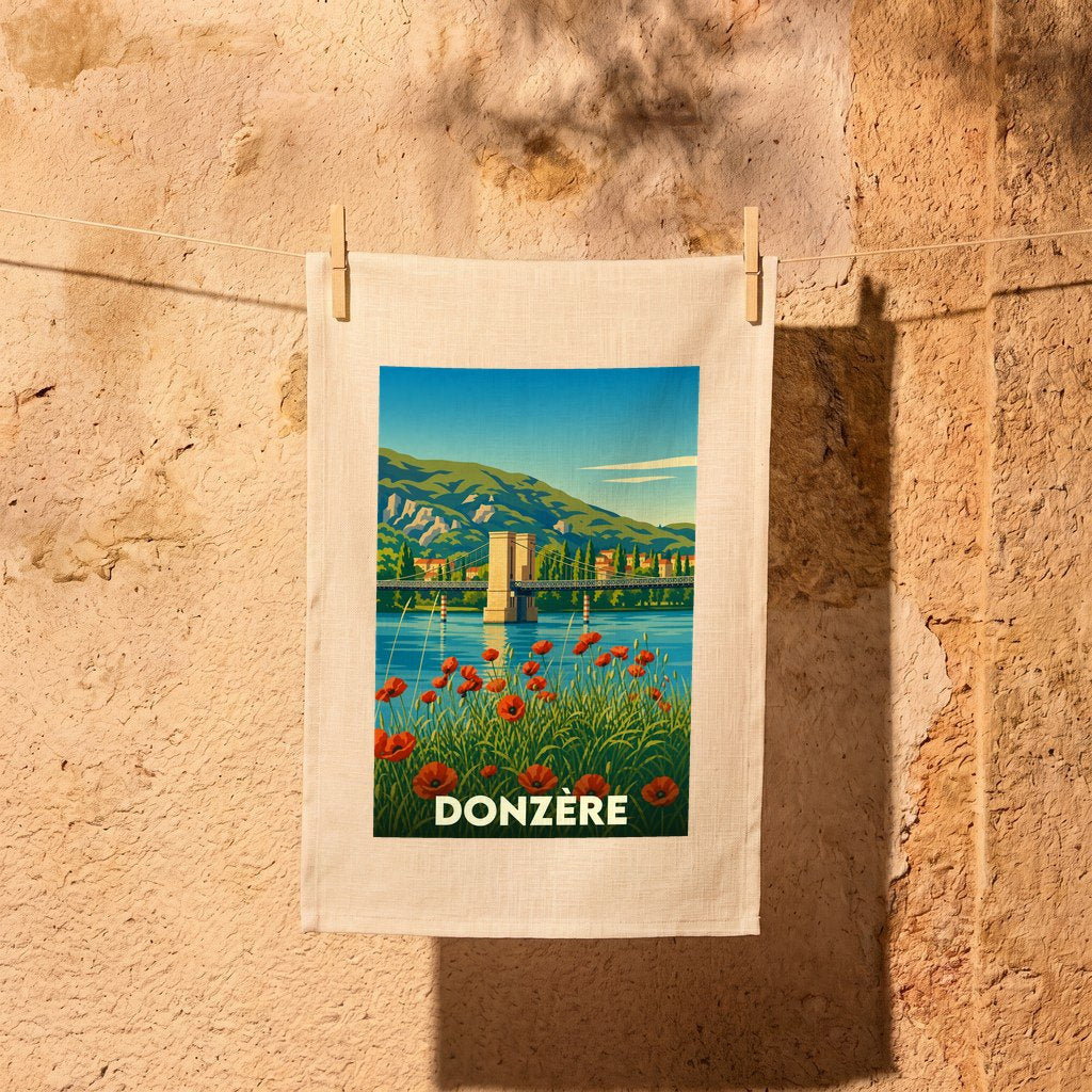 Torchon souvenir de la ville de Donzère avec une illustration stylisée d'un pont et de coquelicots.