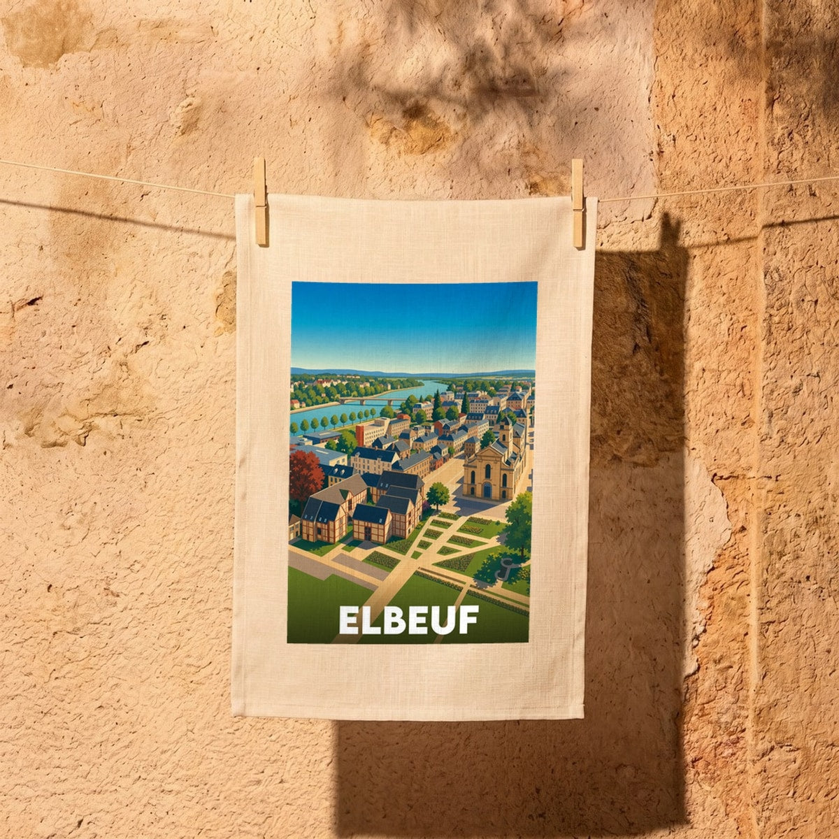 Torchon souvenir de la ville d'Elbeuf avec une illustration stylisée représentant une vue panoramique colorée.
