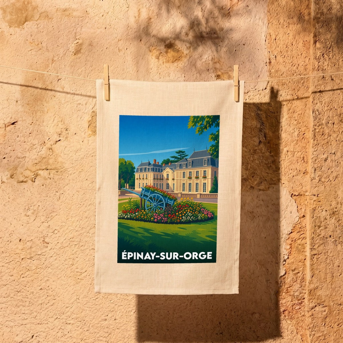 Torchon souvenir de la ville d'Épinay-sur-Orge avec une illustration stylisée d'un château et d'une charrette fleurie.