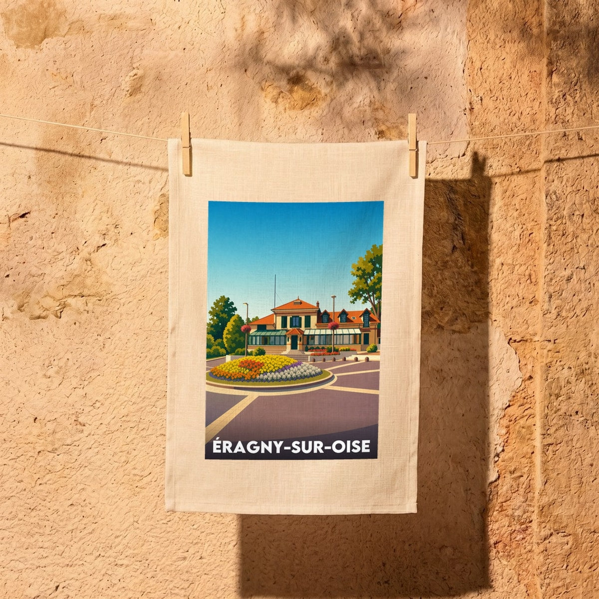 Torchon souvenir de la ville d'Éragny-sur-Oise avec une illustration stylisée.