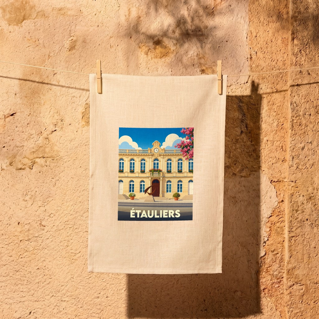 Torchon souvenir de la ville d'Étauliers avec une illustration stylisée de sa mairie sous un ciel bleu.