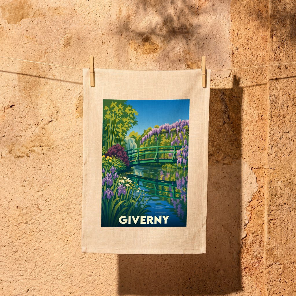 Torchon souvenir de la ville de Giverny avec une illustration colorée du jardin de Claude Monet.