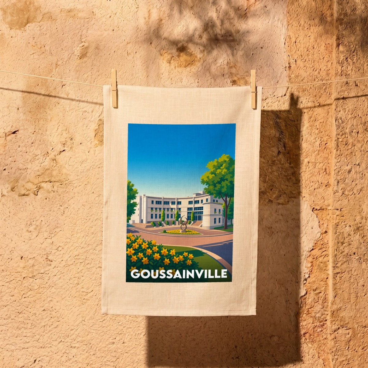 Torchon souvenir de la ville de Goussainville avec une illustration stylisée de son architecture.