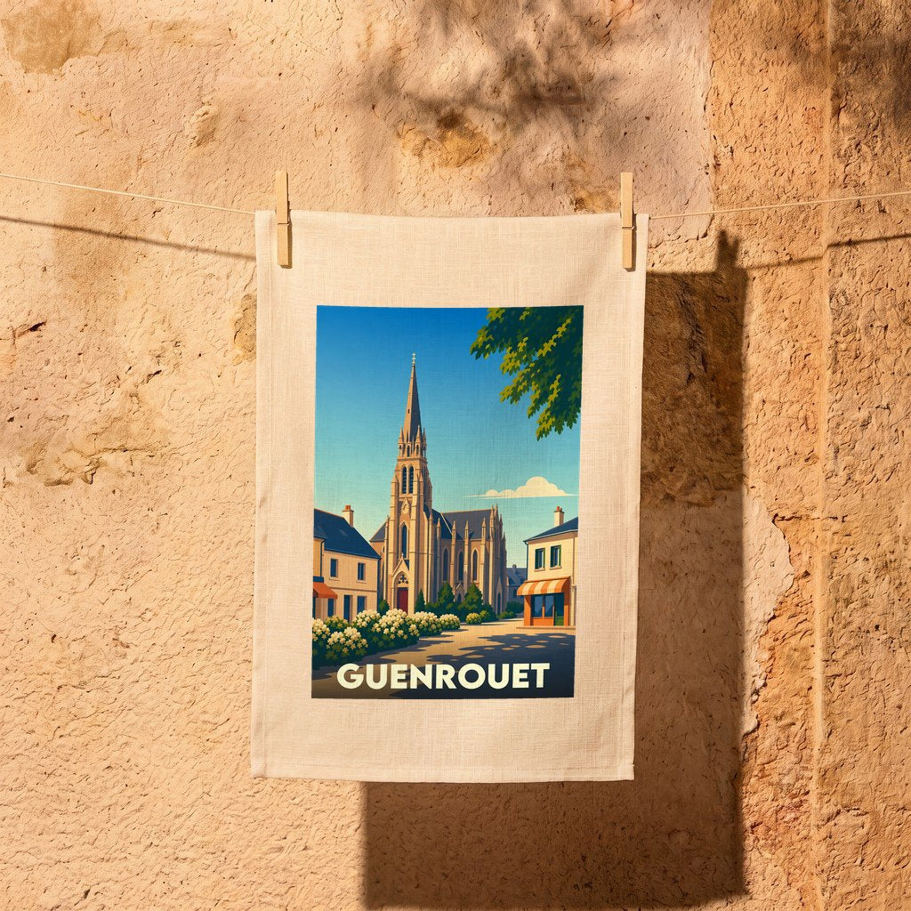 Torchon souvenir de la ville de Guenrouet illustré d'une vue stylisée de son église et suspendu devant un mur en pierre.