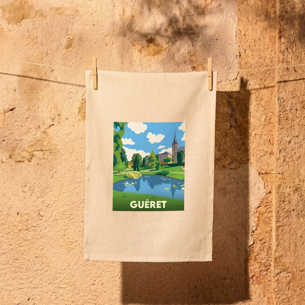 Torchon souvenir de la ville de Guéret avec une illustration stylisée d'une fontaine sur une place.