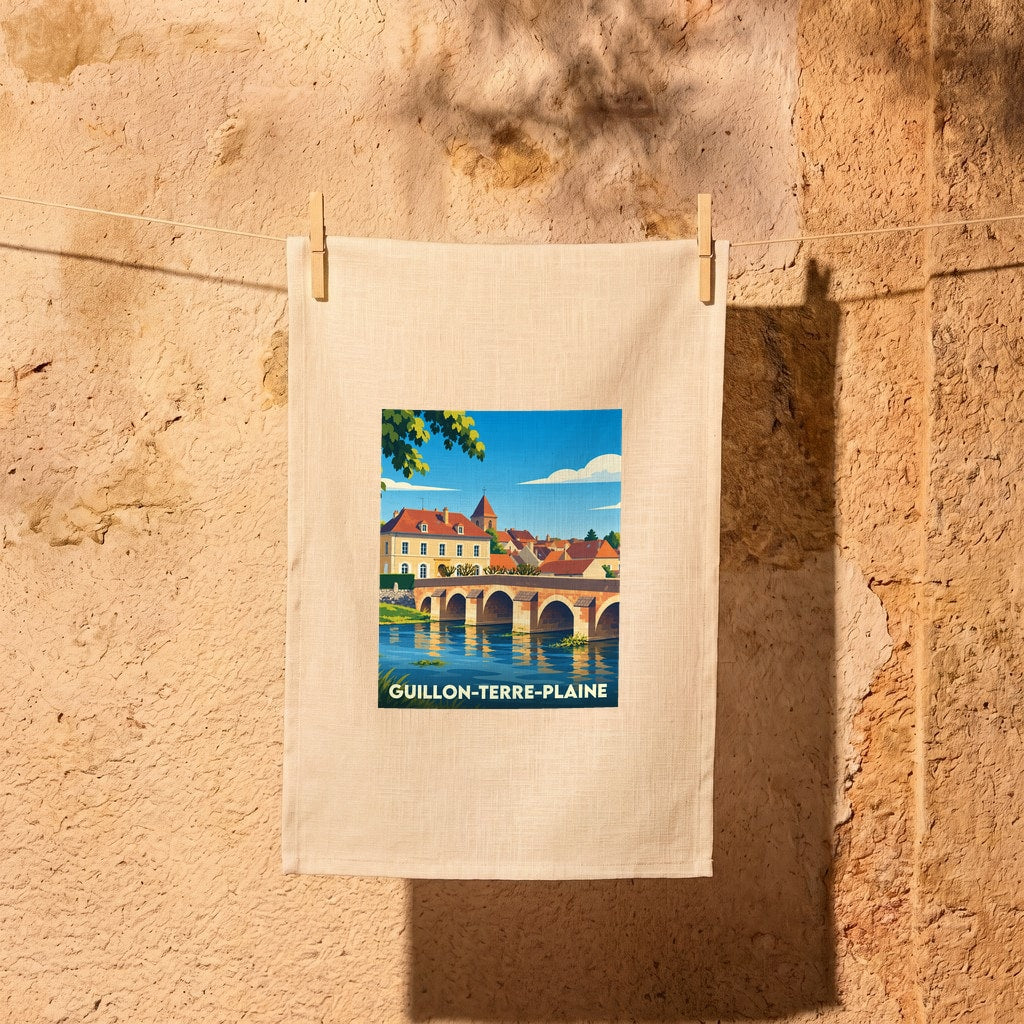 Torchon souvenir de la ville de Guillon-Terre-Plaine avec une illustration stylisée d'un pont en pierre.