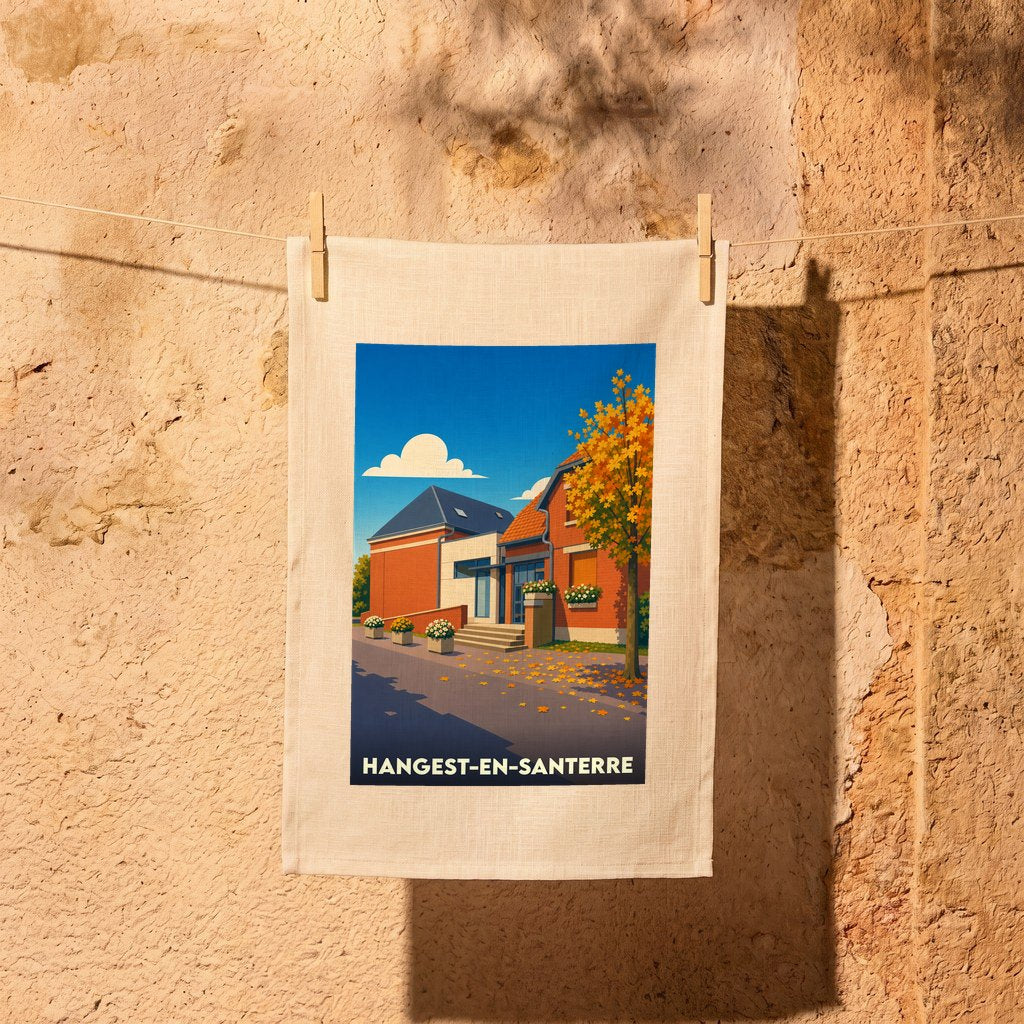 Torchon souvenir de la ville de Hangest-en-Santerre avec une illustration stylisée d'une rue en automne.