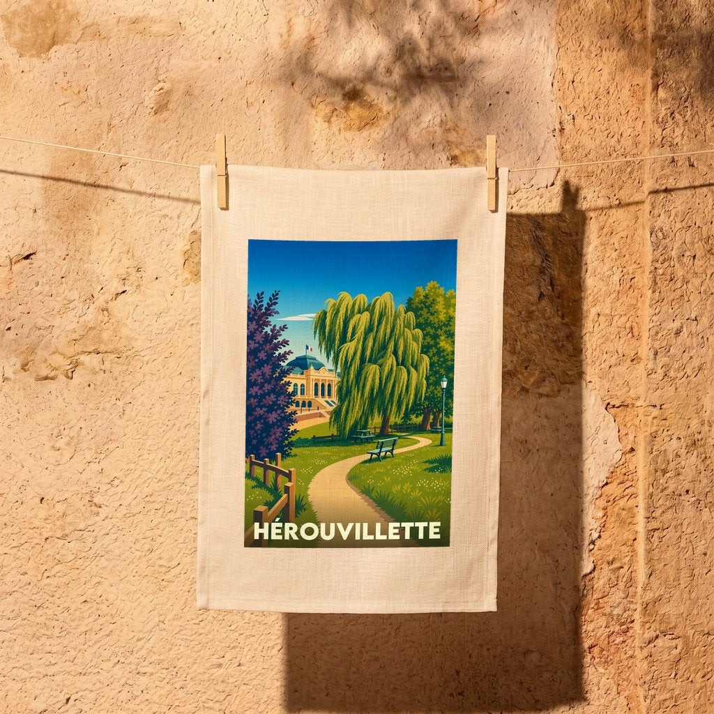 Torchon souvenir de la ville de Hérouvillette avec une illustration stylisée d'un parc arboré.