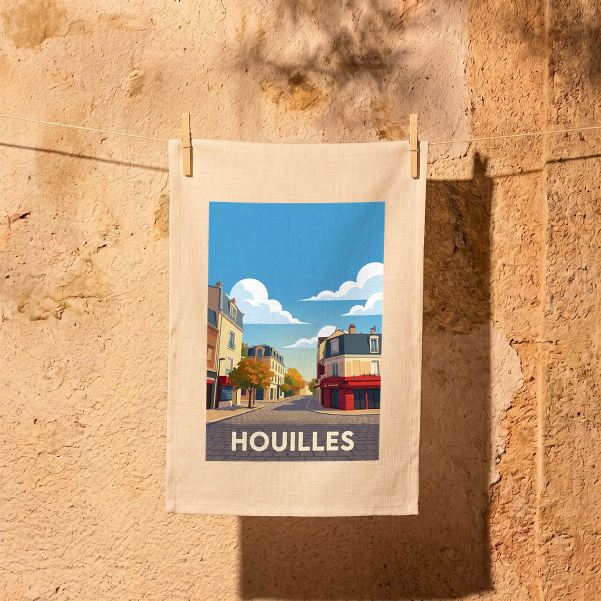 Torchon souvenir de la ville de Houilles avec une illustration stylisée.