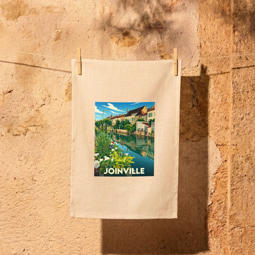 Torchon souvenir de la ville de Joinville avec une illustration stylisée d'un canal fleuri.