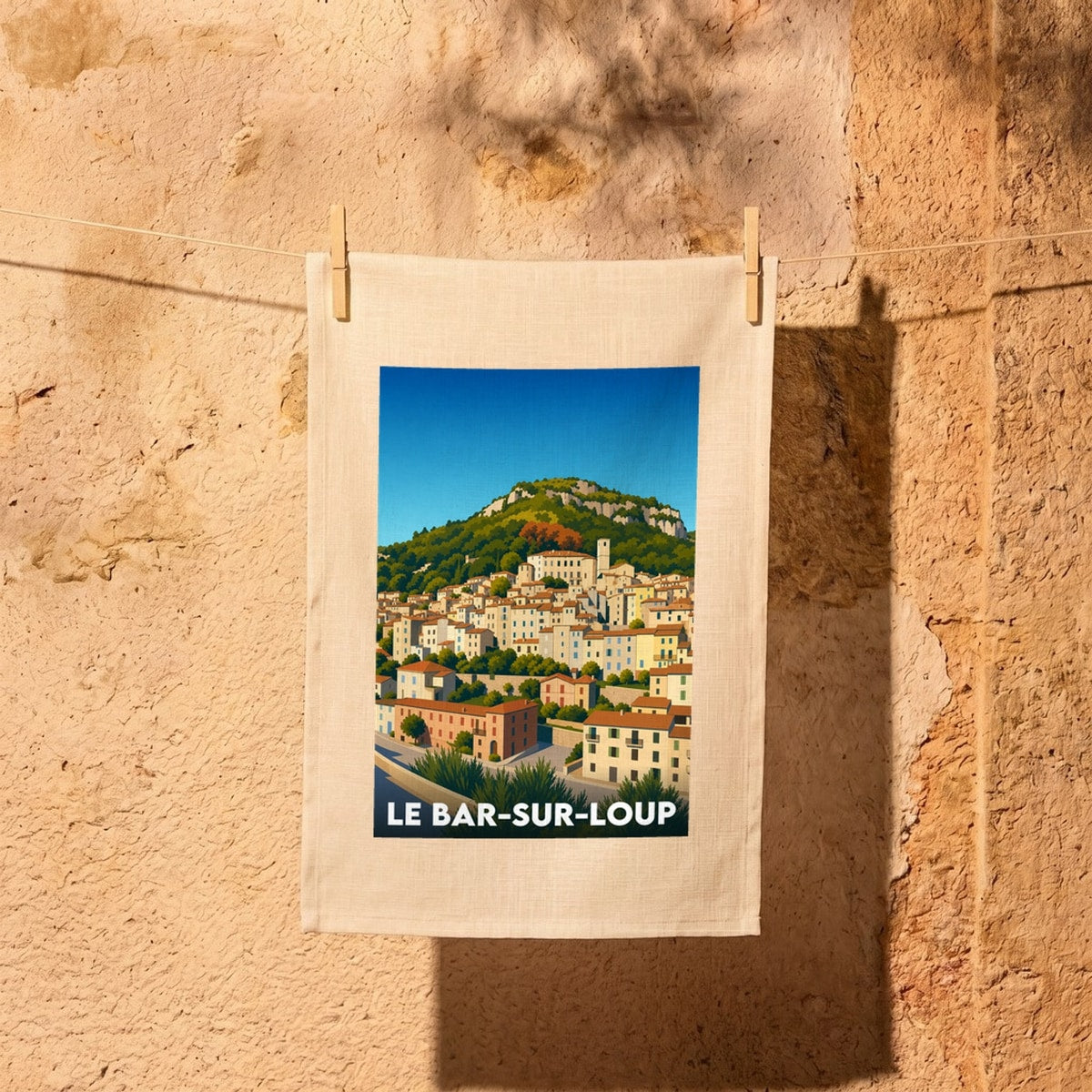 Torchon souvenir de la ville de Le Bar-sur-Loup avec une illustration stylisée du village perché.
