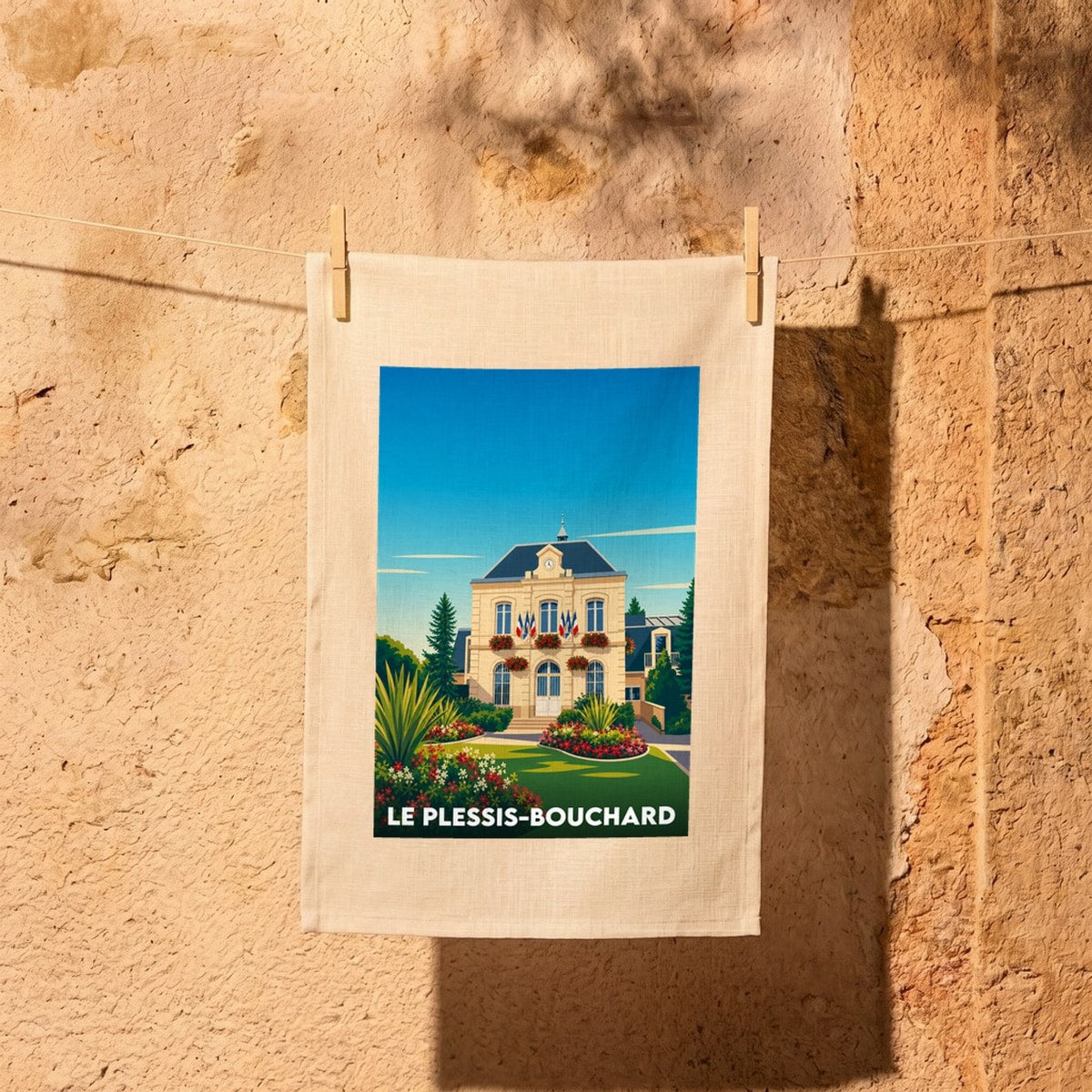 Torchon souvenir de la ville de Le Plessis-Bouchard avec une illustration stylisée de son hôtel de ville.