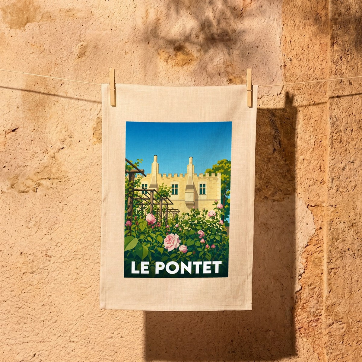 Torchon souvenir de la ville de Le Pontet avec une illustration stylisée d'un château et de roses.